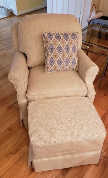 Recovered chair and ottoman set with an accent pillow to pull in the matching chair